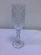 Clear glass goblet with intricate patterns on a white background