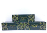 Two green boxes with gold floral patterns on a white background