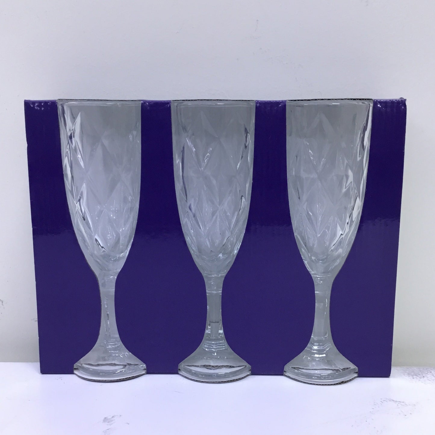 Set of three wine glasses with a blue rim on a white background