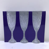 Set of three wine glasses with a blue rim on a white background