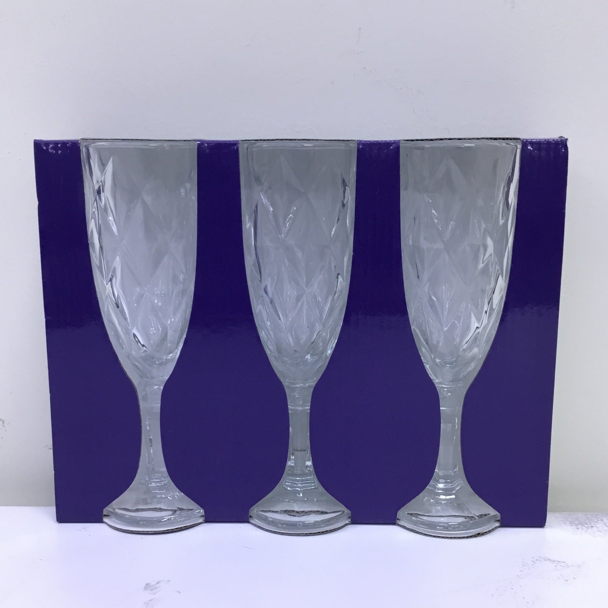 Set of three wine glasses with a blue rim on a white background
