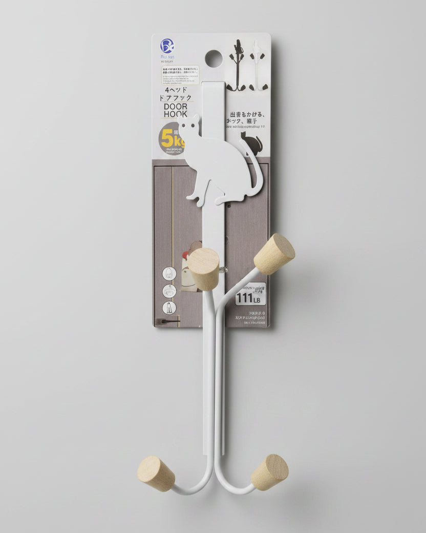 Metal bracket with wooden pegs on a white surface