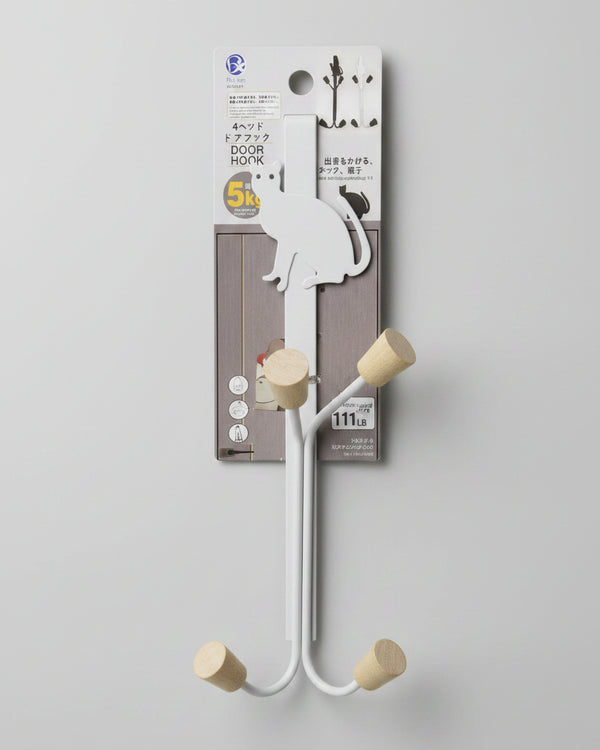Metal bracket with wooden pegs on a white surface