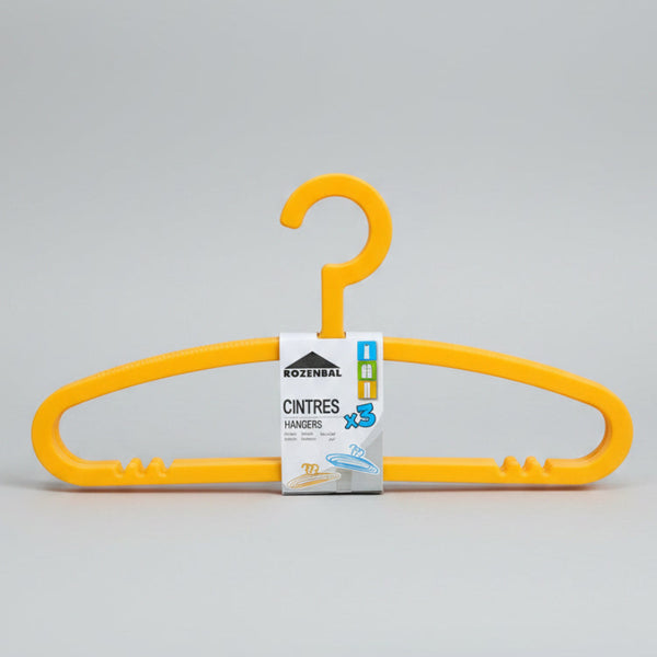 Yellow hanger with a brand label on a metal surface in a store setting