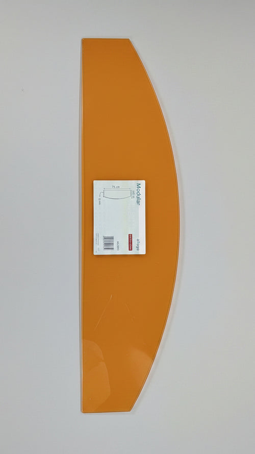 Orange skateboard deck with a label on a white surface