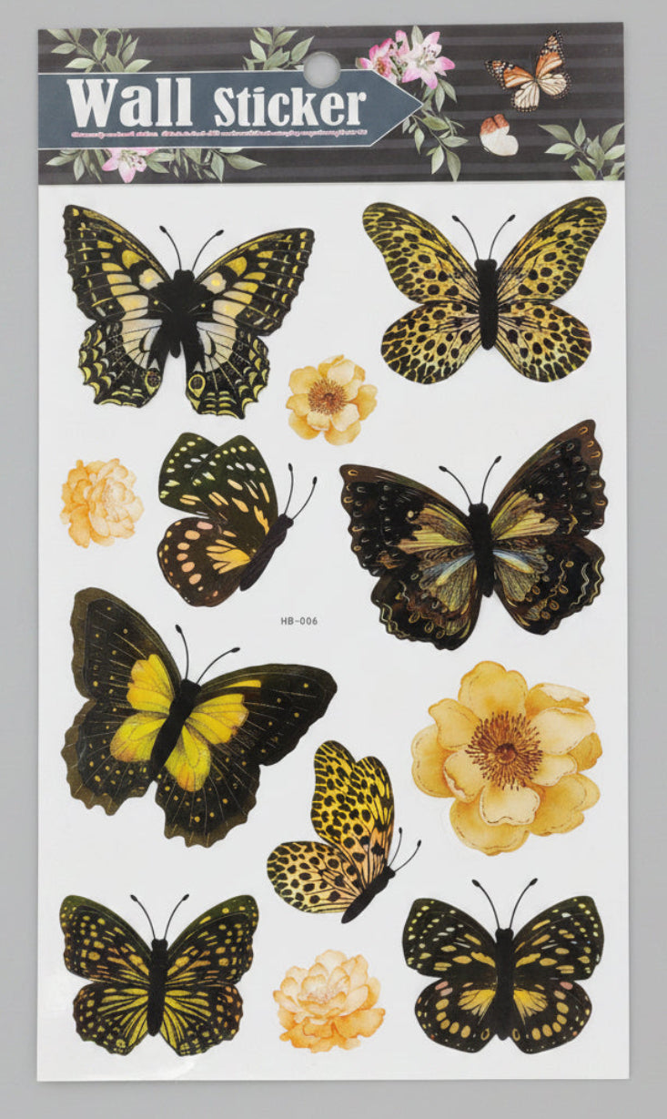 Packaged wall stickers with butterfly and flower designs on a gray surface.